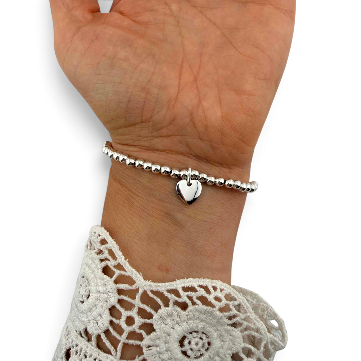 ANNA VON BERGMANN PUSCHEL Armband aus Sterlingsilber mit Herzanhänger und elastischem Band am Handgelenk
