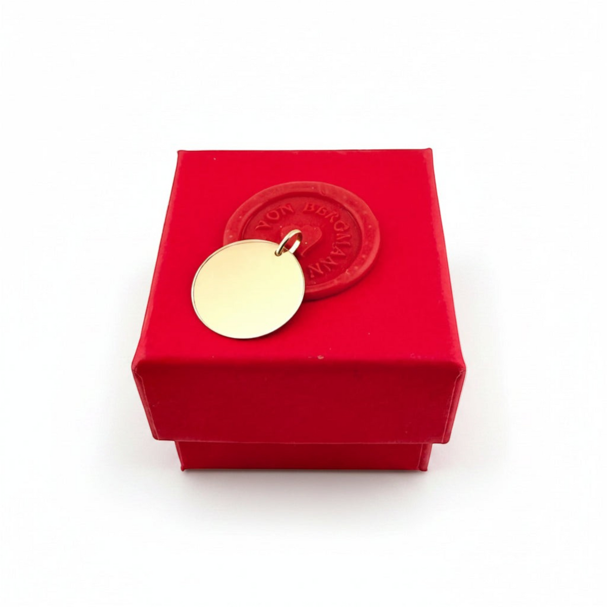 ANNA VON BERGMANN runder Anhänger aus 375er Echtgold auf einer roten Geschenkbox mit Siegel